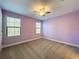 Bright bedroom showcasing two windows, carpet, and neutral walls at 4132 Woods Rider Loop, Odessa, FL 33556