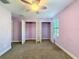 Bedroom featuring carpet, a ceiling fan, two windows, and a closet at 4132 Woods Rider Loop, Odessa, FL 33556
