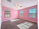 Bright pink bedroom with carpet, and natural light from the windows at 4132 Woods Rider Loop, Odessa, FL 33556