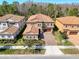 Aerial view of a beautiful home with a red tile roof and brick driveway at 4132 Woods Rider Loop, Odessa, FL 33556