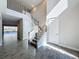 Elegant foyer with staircase, tile floors, and natural light at 4132 Woods Rider Loop, Odessa, FL 33556