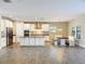 Bright, open-concept kitchen featuring stainless steel appliances, granite countertops, and a dining nook at 4132 Woods Rider Loop, Odessa, FL 33556