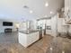 Open kitchen with a large island, stainless steel appliances, and views of the living area at 4132 Woods Rider Loop, Odessa, FL 33556