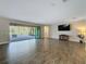 Spacious living room with tile floors and access to the outdoor patio at 4132 Woods Rider Loop, Odessa, FL 33556