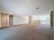 Spacious living room with neutral walls, carpet, and a staircase leading to the upper level at 4132 Woods Rider Loop, Odessa, FL 33556