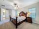 Spacious main bedroom with a ceiling fan, natural light, and access to the main bathroom at 4132 Woods Rider Loop, Odessa, FL 33556
