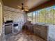 Outdoor kitchen with stainless steel appliances and ample counter space with a ceiling fan at 4132 Woods Rider Loop, Odessa, FL 33556