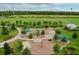 Aerial view of a playground in a park with trees, grass, and other outdoor recreational areas at 4132 Woods Rider Loop, Odessa, FL 33556