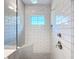 Modern walk-in shower with white subway tile, a built-in bench, and rainfall showerhead at 4132 Woods Rider Loop, Odessa, FL 33556