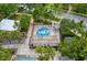 Aerial view of splash pad with benches and palm trees nearby a pool at 4132 Woods Rider Loop, Odessa, FL 33556