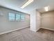 Spacious walk-in closet with carpet, custom shelving, and natural light from a window at 4132 Woods Rider Loop, Odessa, FL 33556