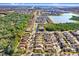 An aerial view displays this home's prime location near a lake with a private pool, showcasing the neighborhood's allure at 4512 Paper Mulberry Pl, Riverview, FL 33578