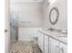 Modern bathroom with glass shower and dual vanity at 4512 Paper Mulberry Pl, Riverview, FL 33578