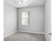 Interior view of the bedroom features neutral walls, plush carpeting, a ceiling fan, and a sunlit window at 4512 Paper Mulberry Pl, Riverview, FL 33578