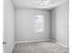 An interior view of a bedroom with neutral walls, plush carpeting, a ceiling fan, and a sunlit window at 4512 Paper Mulberry Pl, Riverview, FL 33578
