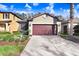 Inviting home with a brown garage door, lush landscaping, and a spacious driveway at 4512 Paper Mulberry Pl, Riverview, FL 33578