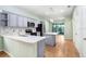 Modern kitchen with stainless steel appliances, marble countertops, light gray cabinetry, and an island at 4512 Paper Mulberry Pl, Riverview, FL 33578