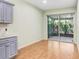 Bright kitchen features wood floors and sliding glass doors at 4512 Paper Mulberry Pl, Riverview, FL 33578