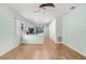 Bright living room with ceiling fan, hardwood-style floors, and views of the kitchen at 4512 Paper Mulberry Pl, Riverview, FL 33578