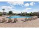 A stunning community pool is surrounded by lounge chairs and a beautiful brick patio at 4512 Paper Mulberry Pl, Riverview, FL 33578