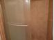 Clean bathroom featuring a glass-enclosed shower and neutral tile at 5100 Burchette Rd # 2103, Tampa, FL 33647