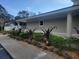Landscaped walkway featuring trimmed shrubs and plants, leading to a neutral-colored building at 5100 Burchette Rd # 2103, Tampa, FL 33647