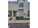 Inviting townhouse exterior featuring a well-manicured front garden and neutral paint scheme at 5100 Burchette Rd # 2103, Tampa, FL 33647