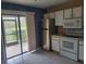 Bright kitchen with stainless steel appliances, white cabinets, and access to the screened patio at 5100 Burchette Rd # 2103, Tampa, FL 33647