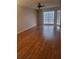 Bright living room featuring hardwood floors, a ceiling fan, and large windows at 5100 Burchette Rd # 2103, Tampa, FL 33647