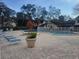 Community pool featuring brick pavers, lounge chairs, and mature trees at 5100 Burchette Rd # 2103, Tampa, FL 33647