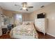 Cozy bedroom featuring a ceiling fan, desk and tropical-themed bedding at 5676 Williams Blvd, Seminole, FL 33772