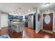 View of a kitchen with blue cabinets, stainless steel appliances, and a granite countertop island at 5676 Williams Blvd, Seminole, FL 33772