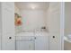 Small laundry room with a side by side washer and dryer at 620 Garland Cir, Indian Rocks Beach, FL 33785