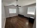 Bright bedroom featuring hardwood floors, a ceiling fan, and natural light from the windows at 6223 Bayshore Blvd, Tampa, FL 33611