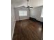 Bright bedroom featuring hardwood floors, a ceiling fan, and natural light from the windows at 6223 Bayshore Blvd, Tampa, FL 33611