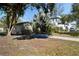 Charming single-story home with mature landscaping, including a palm tree, with a driveway at 6223 Bayshore Blvd, Tampa, FL 33611