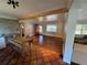 Bright living room featuring hardwood floors, neutral walls, and a red entry door at 6223 Bayshore Blvd, Tampa, FL 33611