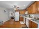 Functional kitchen featuring wood cabinets, white appliances, and hardwood floors at 628 30Th N Ave, St Petersburg, FL 33704