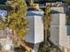 Overhead view of a house with a metal roof, a paved walkway, and mature trees surrounding the property at 6291 Sebring St, Weeki Wachee, FL 34607