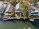 Aerial view of the waterfront home and the canal with a dock and a deck at 6291 Sebring St, Weeki Wachee, FL 34607