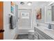 Bright bathroom featuring modern fixtures, a shower-tub combo, and stylish wainscoting at 6291 Sebring St, Weeki Wachee, FL 34607