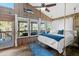 Charming bedroom with a swing bed, wood paneling, and natural light streaming through the windows at 6291 Sebring St, Weeki Wachee, FL 34607