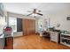Cozy bedroom with hardwood floors, closet, a ceiling fan, natural light, and a workspace at 6291 Sebring St, Weeki Wachee, FL 34607