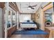 Charming bedroom with a swing bed, wood paneling, and natural light streaming through the windows at 6291 Sebring St, Weeki Wachee, FL 34607