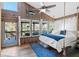 Bright bedroom with wood paneled walls, sunroom access, and a hanging rope bed at 6291 Sebring St, Weeki Wachee, FL 34607