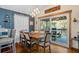 Inviting dining room with wood floors and balcony access with a view of natural outdoor scenery at 6291 Sebring St, Weeki Wachee, FL 34607