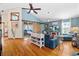 Bright living room featuring hardwood floors, a sliding barn door and stylish blue walls with modern furnishings at 6291 Sebring St, Weeki Wachee, FL 34607