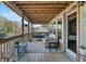 Relaxing porch with a swing bed and wicker furniture, perfect for enjoying outdoor living at 6291 Sebring St, Weeki Wachee, FL 34607