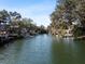 View of a canal with a lush tree line and waterfront homes at 6291 Sebring St, Weeki Wachee, FL 34607