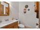 Functional half bathroom with a single sink vanity, toilet, and decorative accents at 6303 23Rd N St, St Petersburg, FL 33702